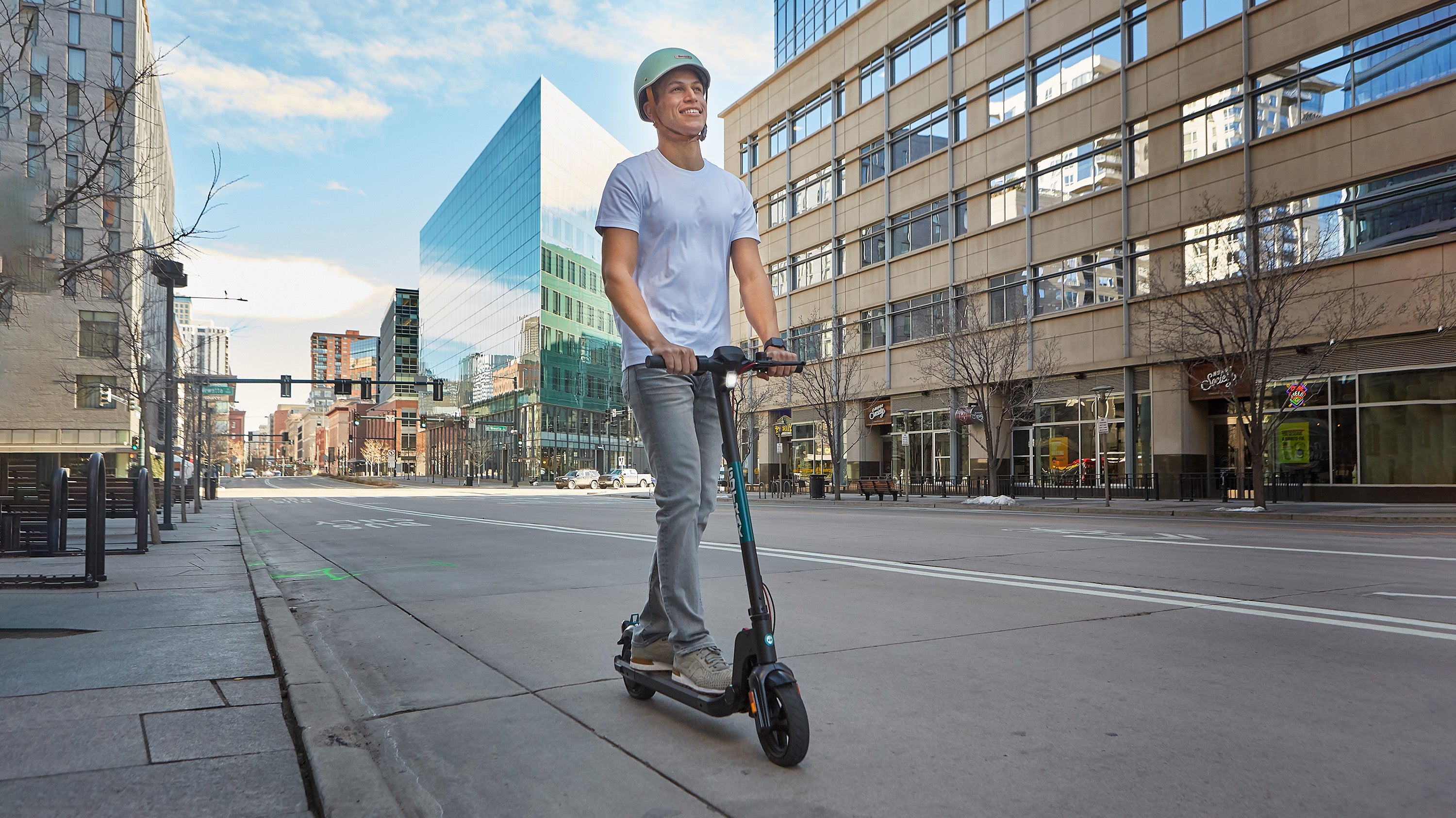 Man riding GOTRAX Black Apex Foldable Entry Level Electric Scooter for Adults