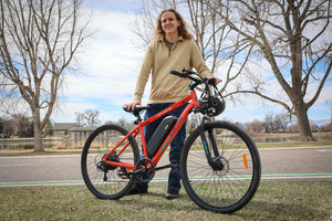 Man holding GOTRAX Traveler Off-Road E-Bike for Adults