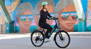 Woman riding GOTRAX White Black Step-Through Electric Bike with Front Wheel Suspension
