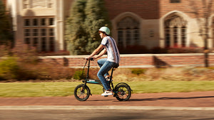 College Student riding GOTRAX Black EBE1 Foldable Electric Bike with Pedal Assist Technology