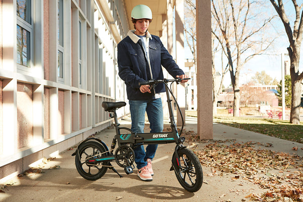 College student with a GOTRAX Black EBE1 Foldable Electric Bike with Pedal Assist Technology