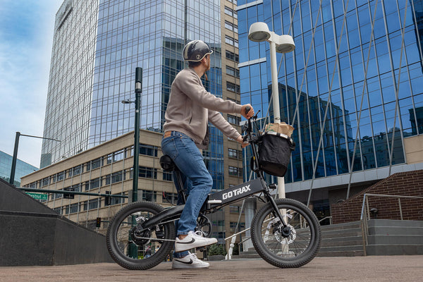 Man on a GOTRAX F1 Foldable Electric Bike with Front Basket Accessory