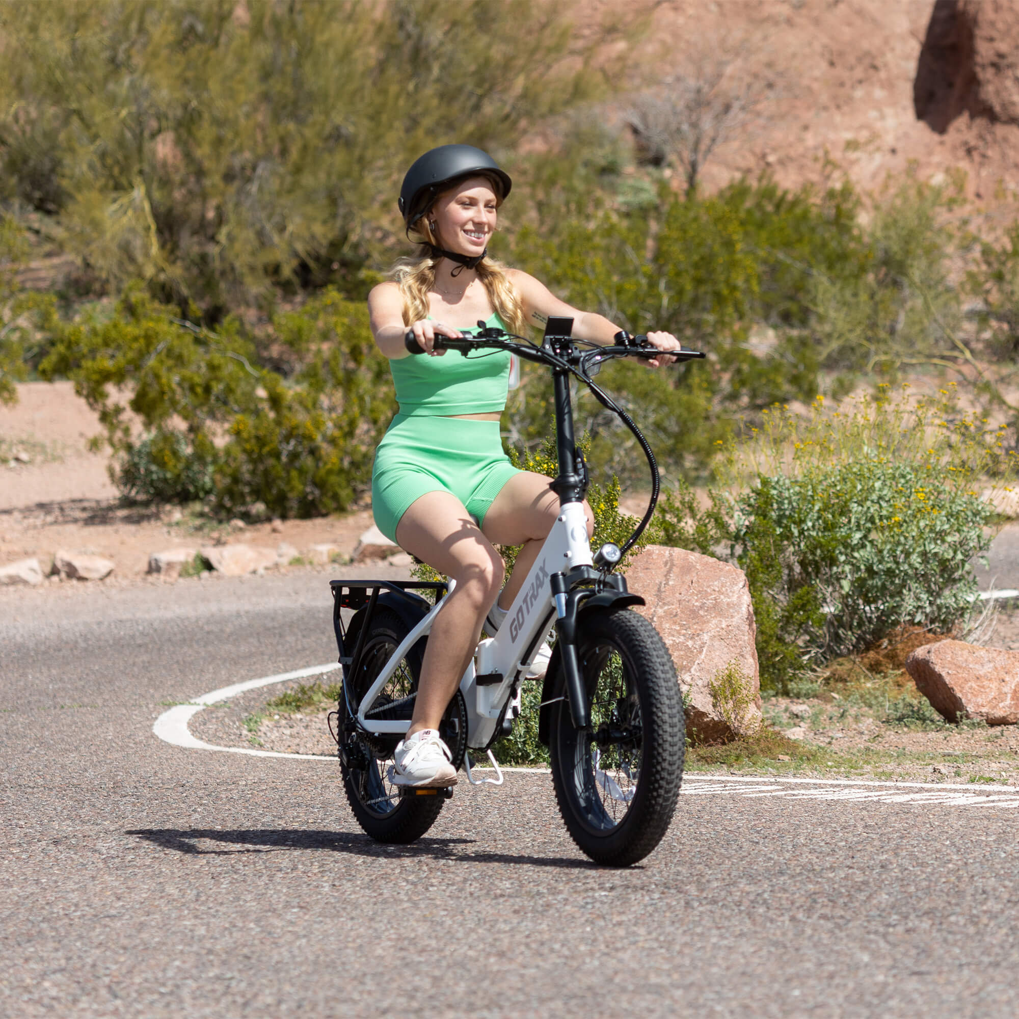 A person riding a GOTRAX F2 Step Thru Foldable Electric Bike
