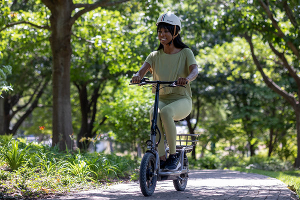 Woman riding the GOTRAX Flex Campus Commuter Electric Scooter