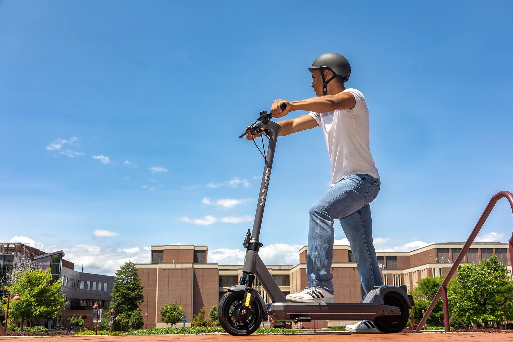Man about to ride on a GOTRAX G5 Commuter Electric Scooter with Front Wheel Suspension