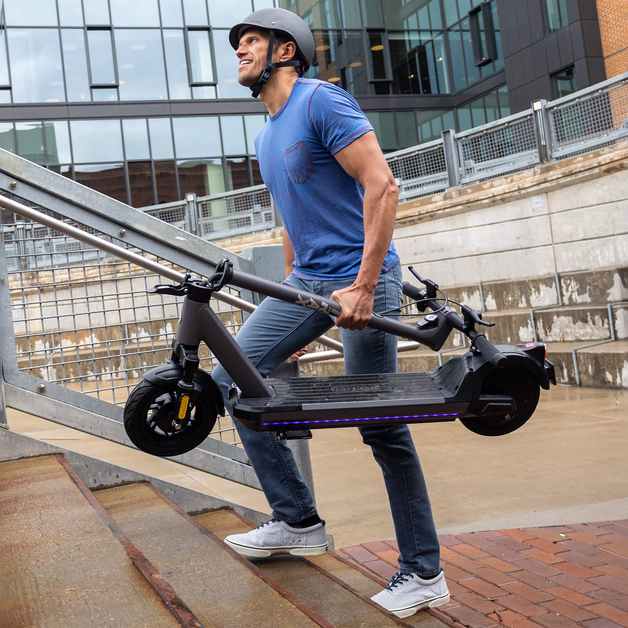 Man carrying the GOTRAX G6 Commuter Electric Scooter in the Folded Position
