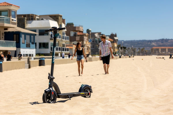 GOTRAX GMAX Commuter Electric Scooter on a beach