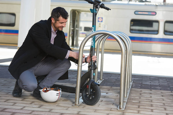 Man using the Integrated Tiller Lock on the GOTRAX GMAX Commuter Electric Scooter