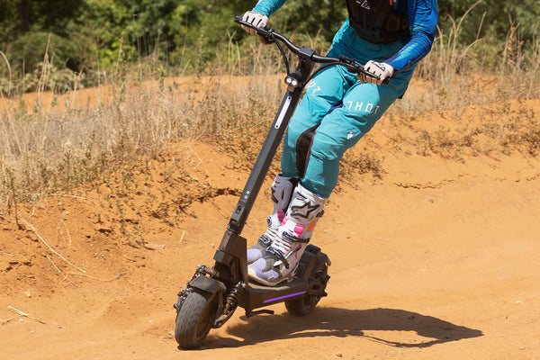 Person riding the GOTRAX GX1 Performance Electric Scooter Off-Road