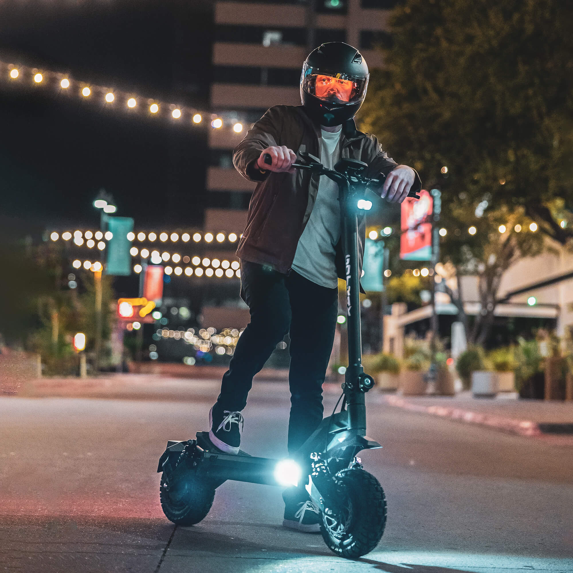 Man standing with a GOTRAX GX3 Performance Electric Scooter