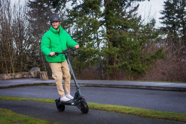 Man riding a GOTRAX GX3 Performance Electric Scooter