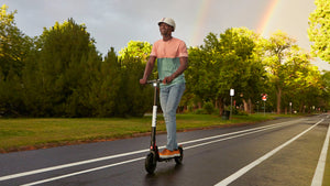 Man Riding GOTRAX Black GXL V2 Foldable Electric Scooter for Adults
