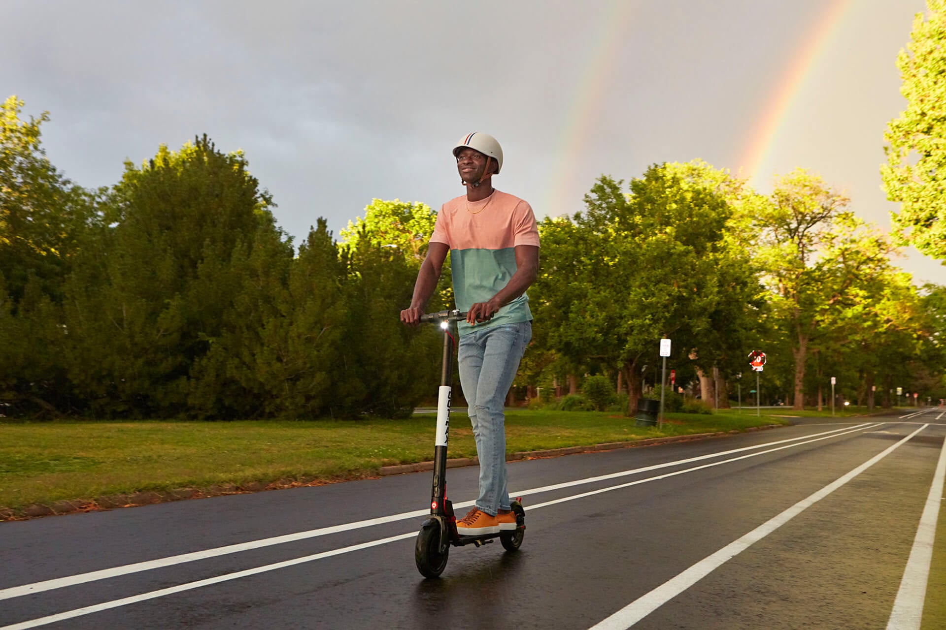 Man riding down a paved path on a GOTRAX GXL V2 Entry Level Electric Scooter