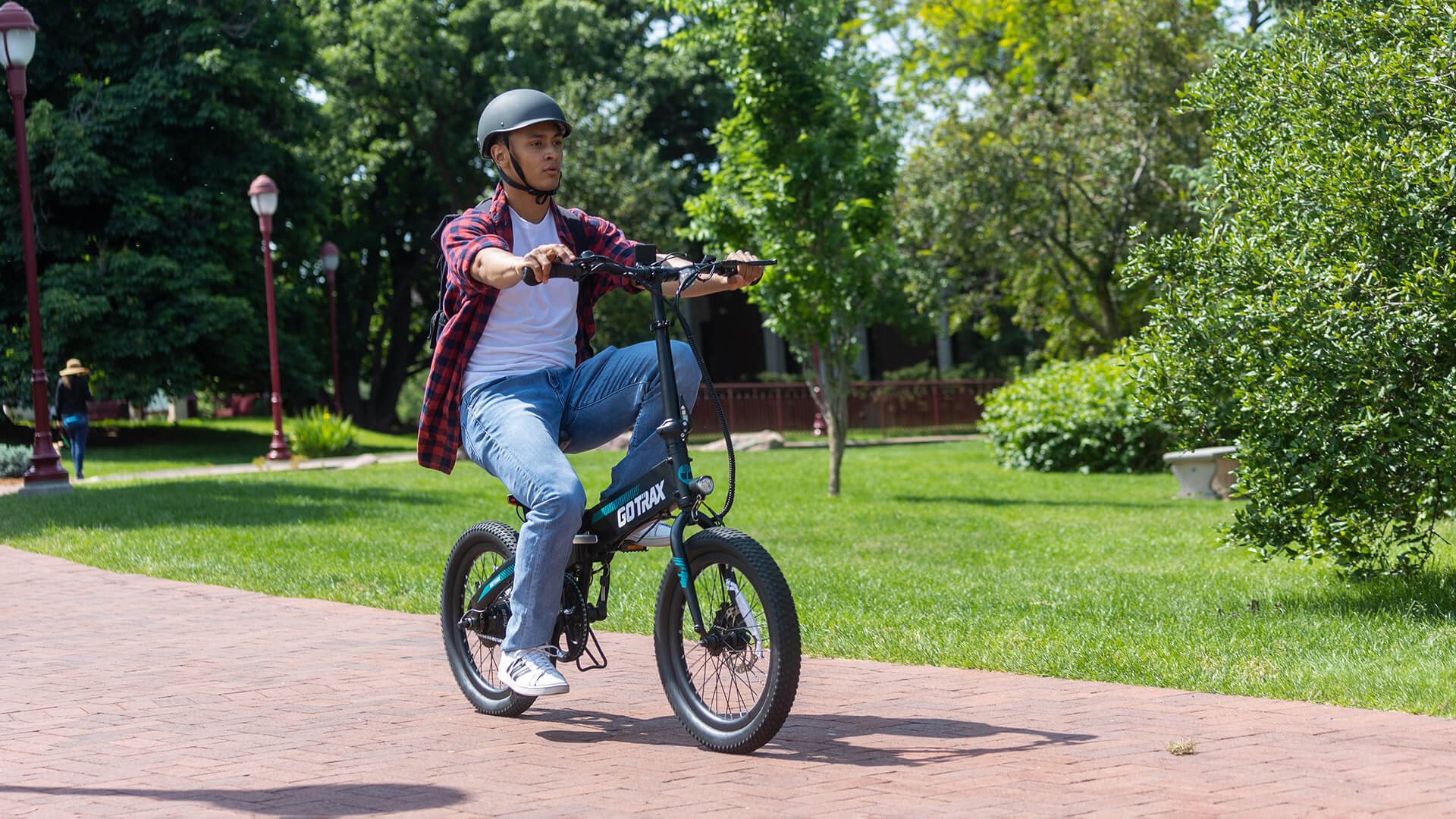 Man riding the R1 Folding Electric Bike through a College Campus
