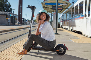 Woman with GOTRAX XR Elite Foldable Electric Scooter for Adults at a Train Station