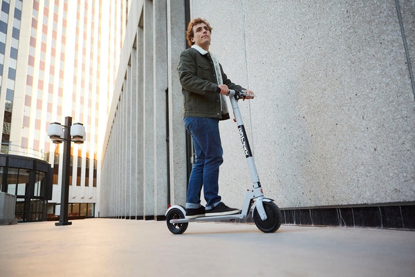 Man riding on a GOTRAX XR Ultra Casual Electric Scooter