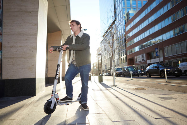Man standing on a GOTRAX XR Ultra Casual Electric Scooter