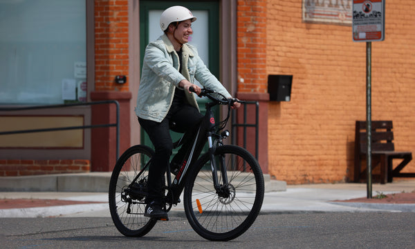 Man riding a GOTRAX Black Alpha XL Electric Bike for Adults with Front Wheel Suspension